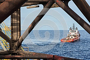 Supply boat stand by nearby the jack up oil and gas rig