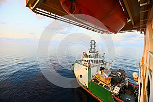 Supply boat transfer cargo to oil and gas industry and moving cargo from the boat to the platform, boat waiting transfer cargo