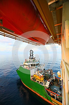 Supply boat transfer cargo to oil and gas industry and moving cargo from the boat to the platform, boat waiting transfer cargo