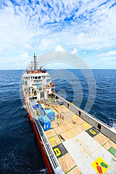 Supply boat transfer cargo to oil and gas industry and moving cargo from the boat to the platform, boat waiting transfer cargo