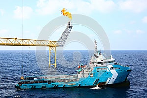 Supply boat transfer cargo to oil and gas industry and moving cargo from the boat to the platform, boat waiting transfer cargo