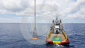 Supply boat for transferring worker by personal basket and cargo to oil and gas industry .