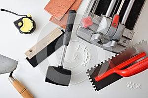Supply of tools and tiling material on table top view