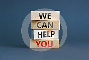 Support and we can help you symbol. Concept words We can help you on wooden blocks. Beautiful grey table grey background. Business