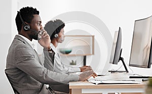 Support, consulting and a black man and woman in call center with headset and computer, help in customer service. Crm