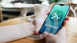 Support, Customer service icon on mobile phone screen. Call center, 24x7 assistance. photo