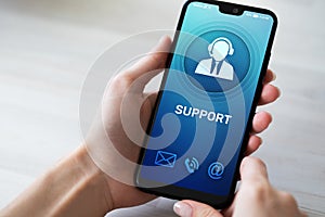 Support, Customer service icon on mobile phone screen. Call center, 24x7 assistance. photo