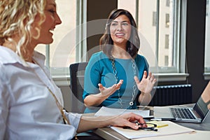 They support each others expression of ideas. two businesswomen having a meeting together in an office.