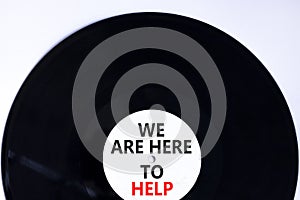 Support and help symbol. Concept words We are here to help on retro black vinyl disc. Beautiful white background, copy space.