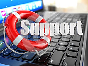 Support. Laptop and lifebuoy on laptop's keyboard.