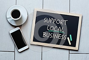 Support Local Business text written on blackboard