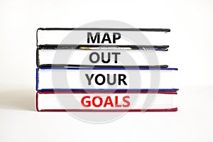 Support and map out your goals symbol. Concept words Map out your goals on books on a beautiful white table white background.
