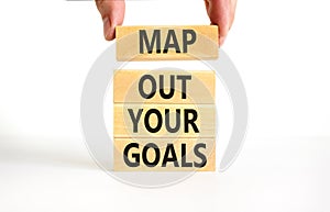 Support and map out your goals symbol. Concept words Map out your goals on wooden blocks on beautiful white table white background