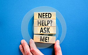 Support and need help ask me symbol. Concept words Need help ask me on wooden blocks on a beautiful blue table blue background.