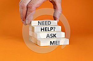 Support and need help ask me symbol. Concept words Need help ask me on wooden blocks on a beautiful orange table orange background