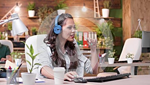 Support operator woman wearing headset talking into microphone with call center customers