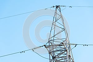 Support of an overhead power line. Transmission of electricity from a powerful power plant to the city. Poles with wires on the
