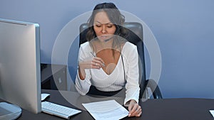 Support phone operator in headset working with laptop in office