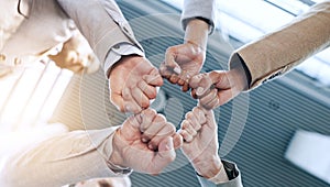 Support, teamwork or business people fist bump in huddle for motivation, group mission or collaboration. Team building