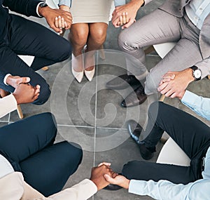 Support, teamwork and unity of business group holding hands and sitting in a circle doing a team building plan. People