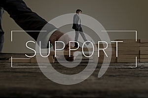 Support text over businessman walking up steps