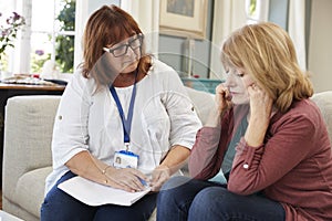 Support Worker Visits Senior Woman Suffering With Depression