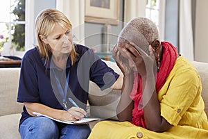 Support Worker Visits Senior Woman Suffering With Depression photo