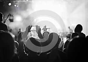 Supporters recording at concert, black and white photo