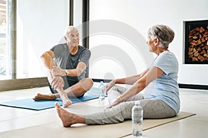 Supporting each other through a healthier, happier lifestyle. a senior couple taking a break while doing yoga together