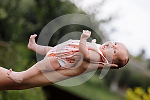 Supporting Hands. Father holding his 14 days old baby girl on his arms