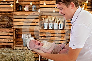 Supporting Hands. Father holding his 14 days old baby girl on his arms