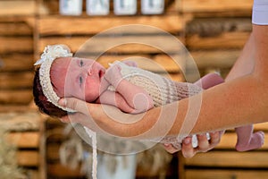 Supporting Hands. Father holding his 14 days old baby girl on his arms