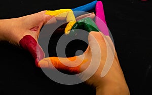 Supporting hands make a heat sign showing homosexuality colours