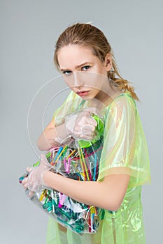 Woman supporting nature holding bag with plastic items photo