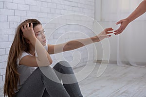 Supporting people with depression. Psychologist offering help to young woman suffering from mental illness photo