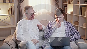 supportive father parent help teaching son laptop