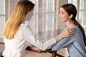 Supportive female doctor comfort woman patient at consultation