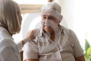 Supportive female nurse take care of senior male patient