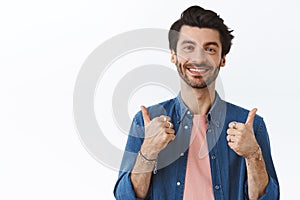 Supportive, good-looking charming boyfriend with beard, show thumbs-up and smiling as give positive feedback, encourage