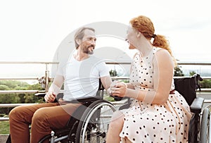 Supportive incapacitated couple enjoying pleasant conversation