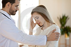 Supportive male doctor comfort patient in hospital