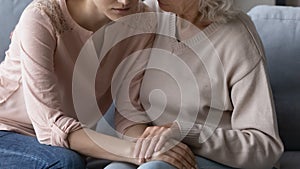 Supportive mature mother comfort upset adult daughter
