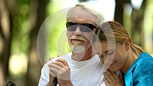 Supportive nurse hugging elderly blind patient, psychological help, rehab center