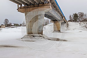 The supports of the bridge over the river Mologa. Winter. Ice. photo