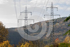 Supports of power lines on the background of a beautiful mountain landscape. Concept: transmission of electricity, power grids and