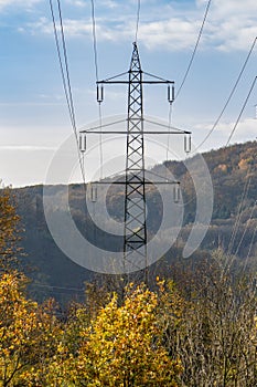 Supports of power lines on the background of a beautiful mountain landscape. Concept: transmission of electricity, power grids and