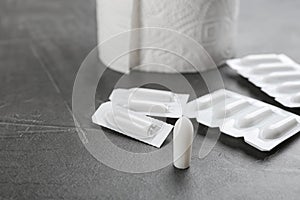 Suppositories on stone table. Hemorrhoid treatment