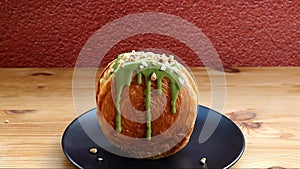 Supreme Croissant Topped with Chopped Nuts and Matcha Green Tea Sauce