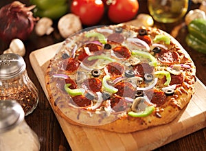 Supreme italian pizza with pepperoni and toppings photo
