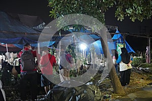 Muslim family buy cow, sheep and goat at night welcoming eid al adha